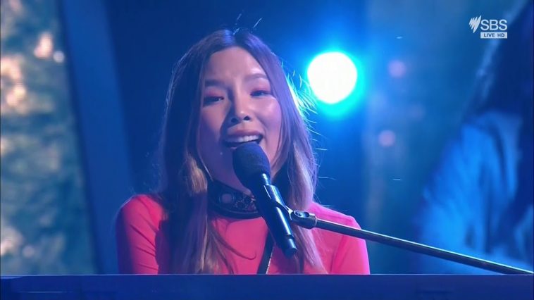 Dami Im performing "Marching On" behind a piano at Eurovision - Australia Decides