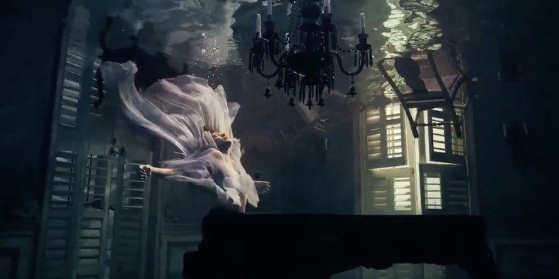 Harry Styles at the piano with two ghosts in his music video for "Falling"