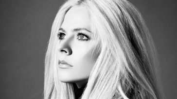 Black and white photo of Avril Lavigne's face as she's looking upwards
