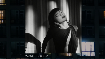 Single cover artwork for "Sober" which sees INNA wearing a black dress and lying back which is hung as a backdrop over a block of flats.