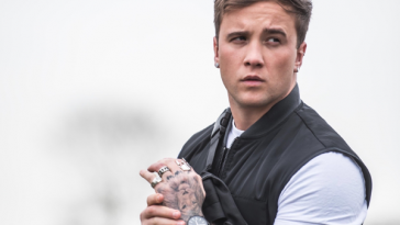 The single artwork of "Something To Prove" which sees Sam Callahan holding his wrist in front of him whilst wearing a short-sleeved white t-shirt and a black bomber jacket.