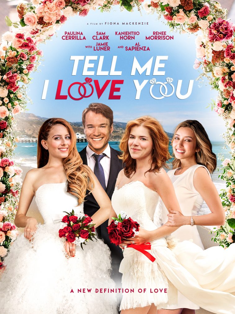 Promotional poster for Tell Me I Love You given to us for our review. It sees Ben dressed in a suit, with Ally and Melanie in wedding dresses and Cassie dressed in white holding on to Melanie's arm. Background is a beautiful landscape of Malibu and the image is bordered with wedding flowers.