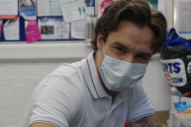 Liam Payne working with the food bank