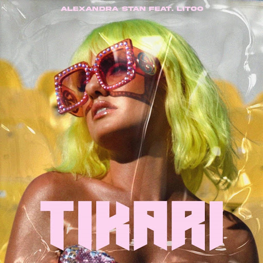 Single artwork for "Tikari" which sees Alexandra Stan wearing a lemon green wig cut into a shoulder-length bob paired with Gucci pink glasses with plastic yellow seats behind her.