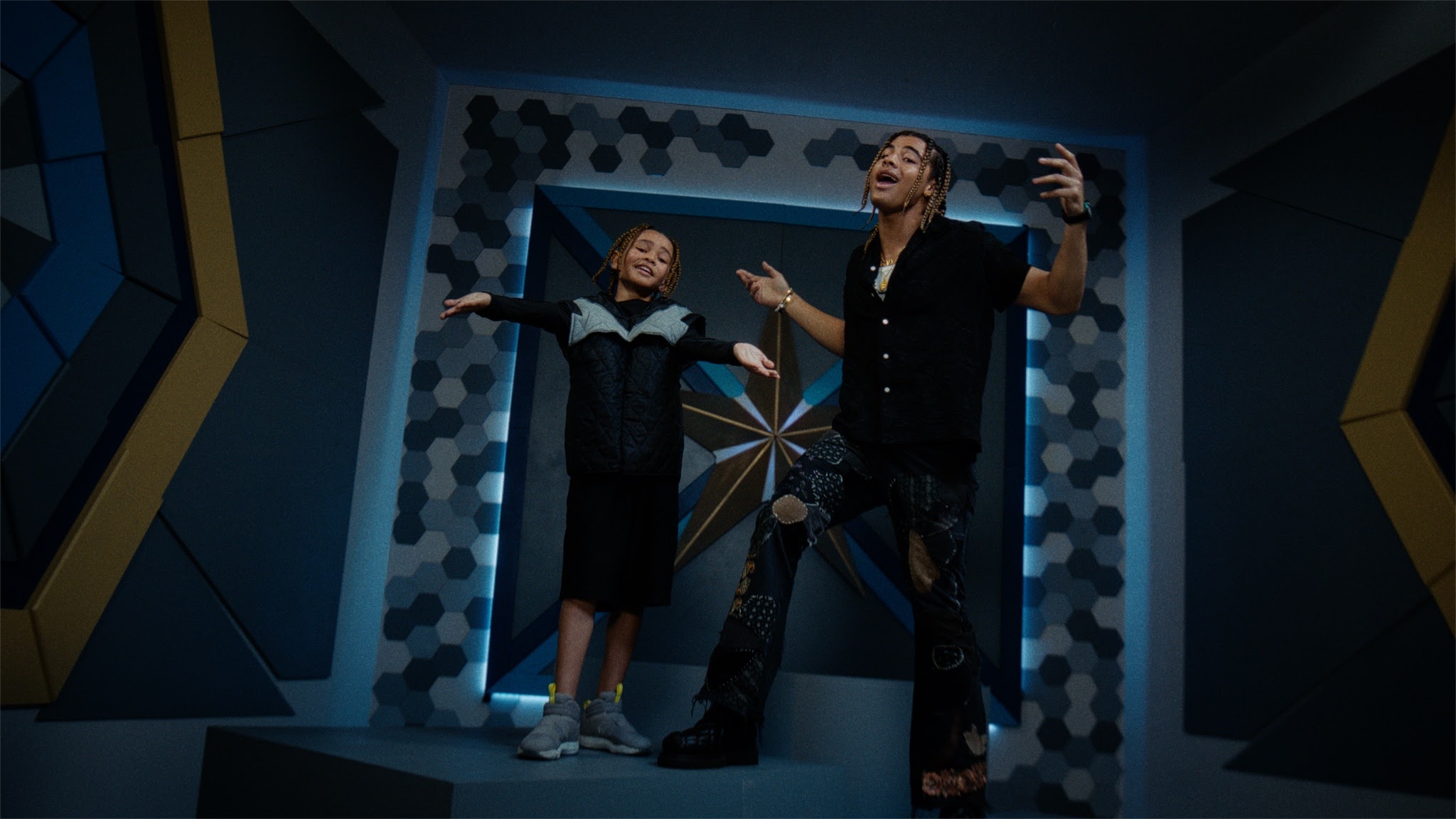 A still of 2kGoldn and his mini me in the "Mosnters" music video