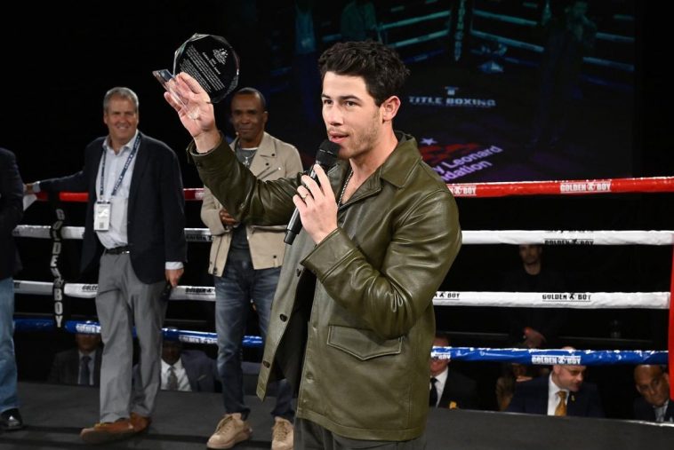 Nick Jonas receiving Golden Glove award