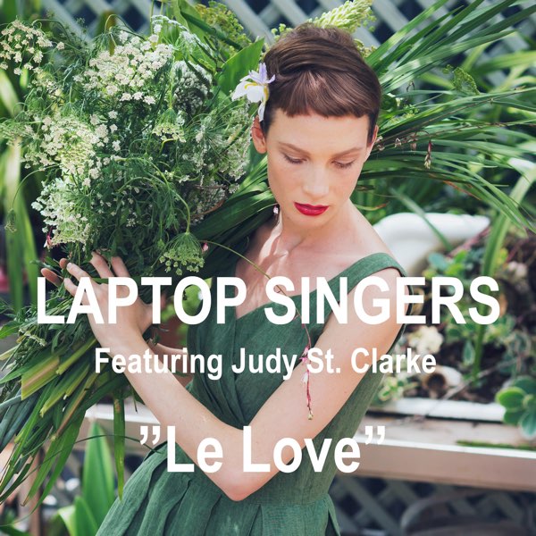 Single cover artwork of "Le Love" by Laptop Singers and Judy St. Clarke, which sees a white woman with short black hair wearing a dark-green fairy dress and pushing some tall leaves out of her way.