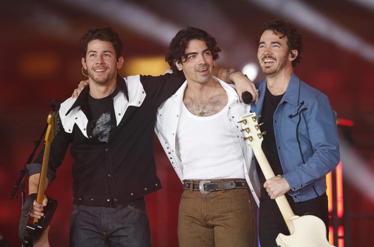 Jonas Brothers performing together in 2022.