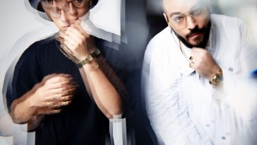 Promotional photo for "Thank Myself" which sees a slightly distorted blurred image of two men with their left hands on their chins, with Capo Corleone on the right wearing a white sweater, and Kuba Wiecek on the right wearing a black t-shirt, a black fedora hat, and a black watch.