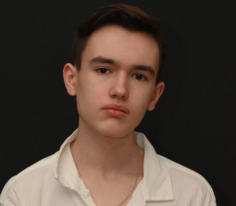 Promotional photo for "Neon" featuring Myah Marie which sees a head shot of Night Acclaim staring into the camera in front of a black background. He is wearing a white shirt and his short black hair is styled.