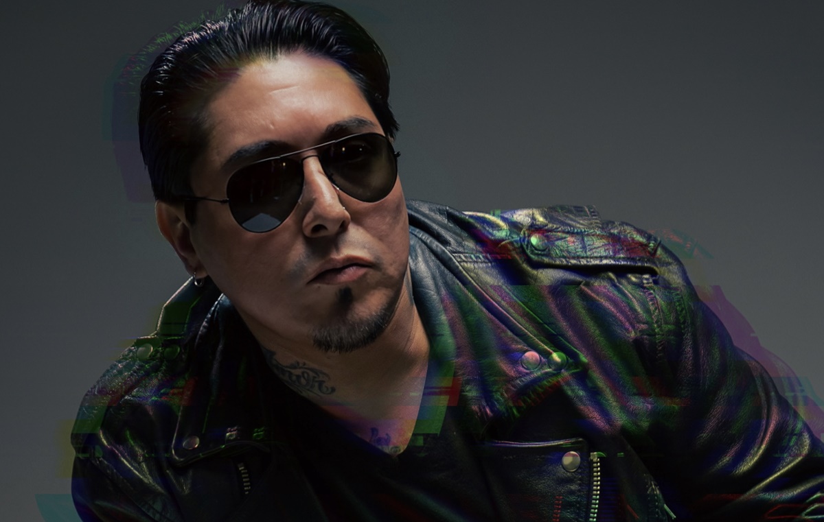 Promotional image for "Changes" which sees Ozie Vox posing at the camera in a head shot, where he's wearing sunglasses and a leather jacket, with his black hair slicked back.
