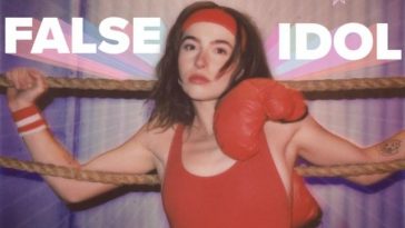 Single cover artwork for "False Idol" which sees MARIS in a red leotard and pink leggings sitting on the side of a boxing arena with her arms hooked over the rope sides.