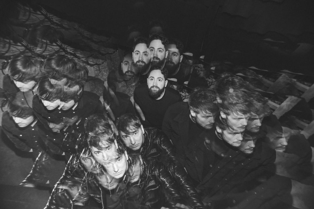 A black and white promotional photo for "Made Me Happy" which has a kaleidoscopic filter with WESSON in the middle and mirrored images of each member expand out to each side of the image.