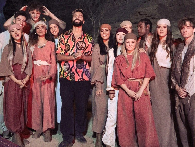 Promotional photo for "Run Till Dark" which sees a group photo of R3HAB with Now United in the oases of AlUla, Saudi Arabia.