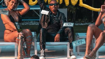Official single cover artwork, which is set around a pool, with Solomon inside the water right on the edge, topless, while J Young MDK is on the side in a seat, wearing black from head to toe, with some black converse. On either side of him are the two Lustt Models.
