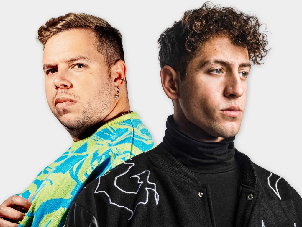 Promotional photo for "Lo Que Siento" which sees a photoshopped image of Tom Enzy and Gian Varela together, with the former on the left, looking over his right shoulder and wearing a blue and yellow swirly jacket, whilst Gian Varela is on the right, looking slightly to the right with his back to Tom Enzy; he is wearing a black turtleneck under a black varicose jacket that has white squiggly lines over it.