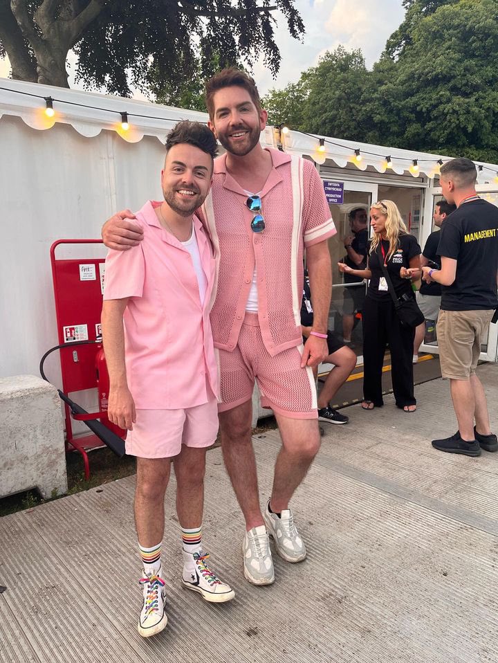 Two guys dressed in pink clothing at Pride Cymru.