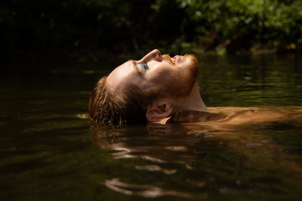 Promotional photo for "Found My Person" which is a side-shot of Blair Davie as they are submerged half in water with their face looking up to the sky.