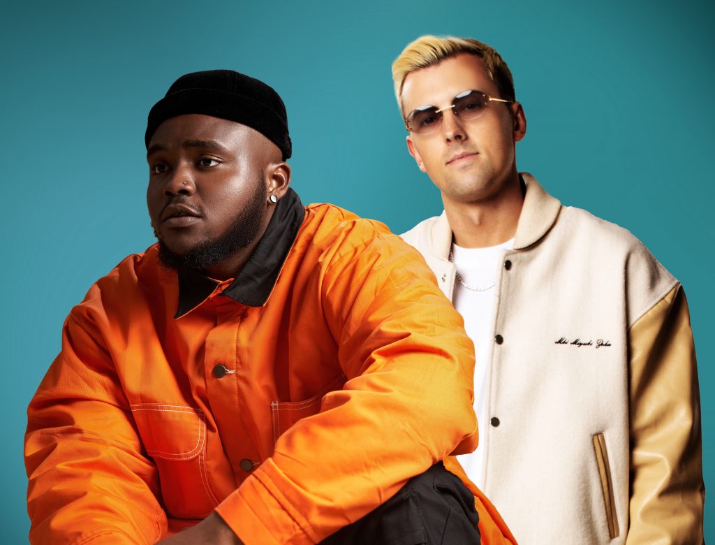 Promotional image for "Boundaries" which is a photoshopped image which sees Phaemous in a bright orange jacket and a black beanie hat overlaying DJames, who is wearing an off-white jacket over a white t-shirt, paired with dark shades that contrasts with his short blonde hair.