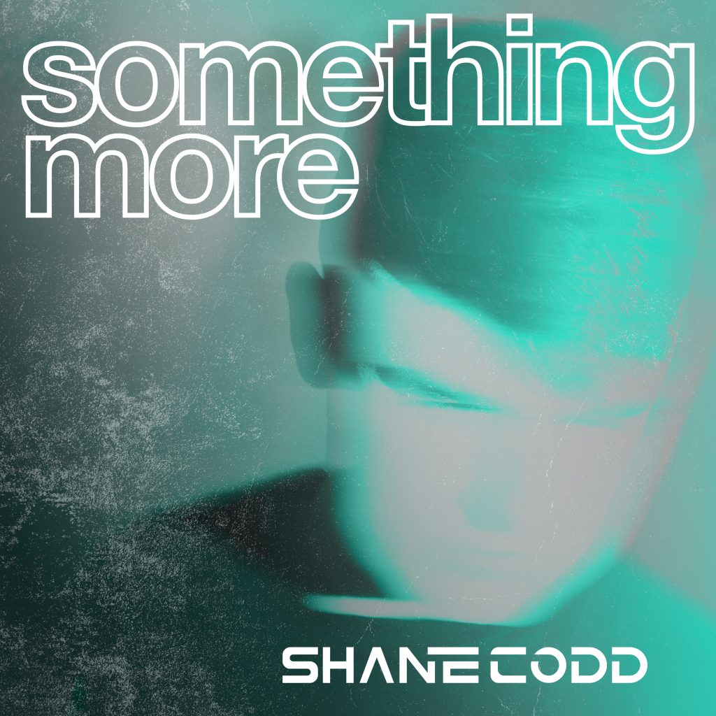 Single cover artwork for "Something More" which sees a blurred image of Shane Codd looking down with a light blue filter. The title letters are at the top, outlined in white, and his name is in the bottom right.