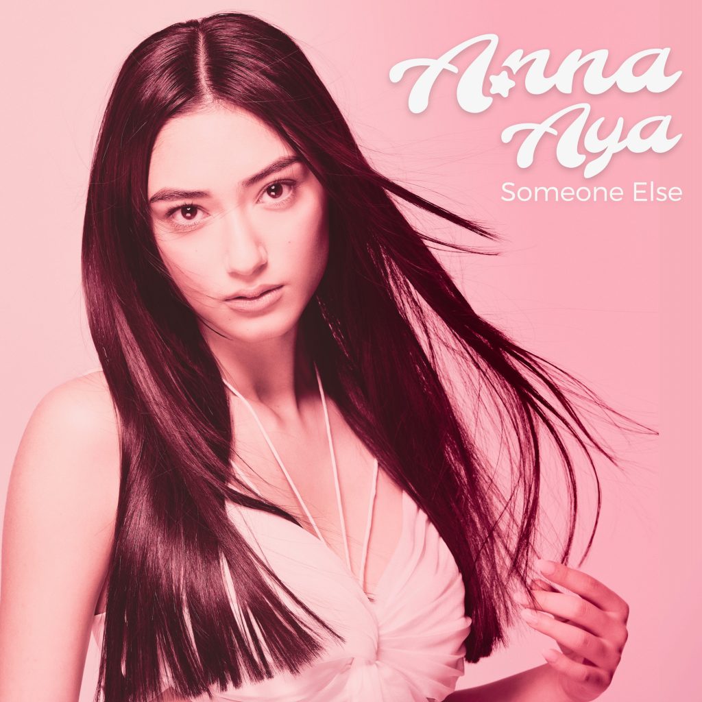 Single cover artwork for "Someone Else" which sees Anna Aya posing with a slight wind-blown look. The image has a pink filter to it.