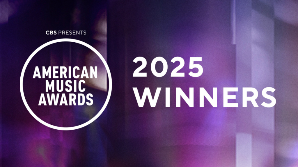 Billie Eilish holding her AMA trophy on stage at the 2025 American Music Awards.