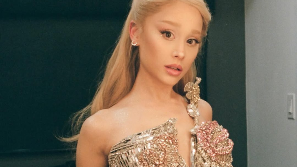 Ariana Grande walking through a dimly lit, water-flooded room in the “Twilight Zone” music video.