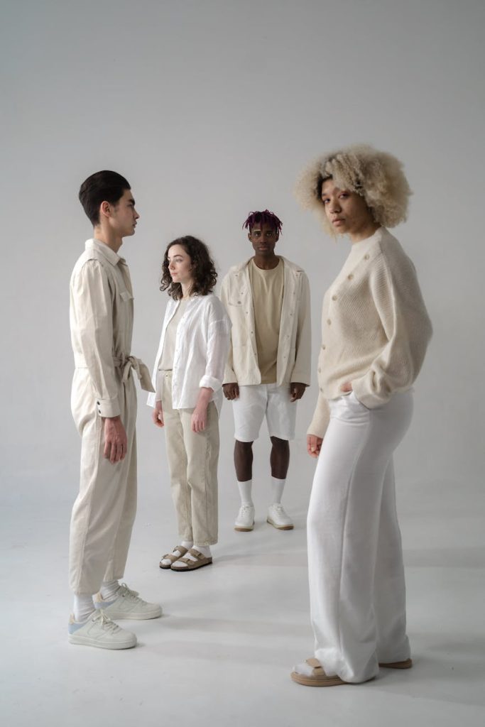 The Coordinated Fashion Trend Celebrities Can’t Stop Wearing photo of men and women in beige and white clothes